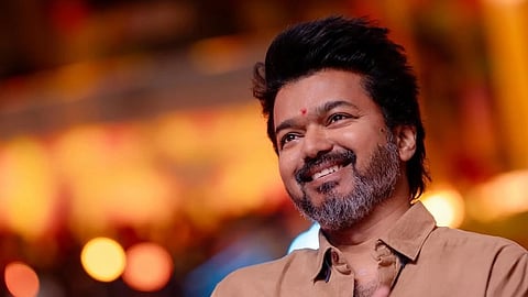 In the image Vijay is shown laughing 