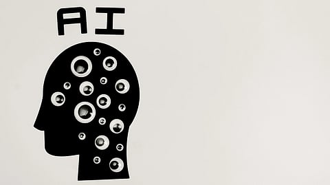 Silhouette of a head filled with various-sized googly eyes, with "AI" above it, set against a plain white background, suggesting AI observation.