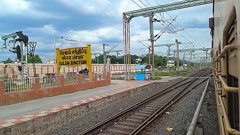 train tracks and platform as seen from side of a train, with a board reading 'salem junction'