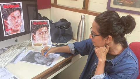 Chinki Sinha signing a cover of an Outlook copy