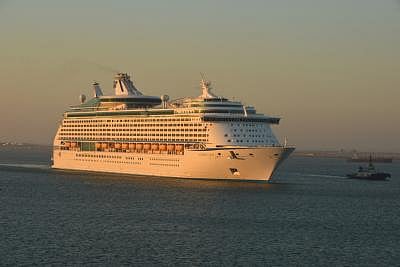 In the image a cruise ship is shown in a long stretched sea