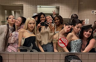 In the image many celebrities are shown clicking pictures with Bhavitha Mandava smiling in a mirror selfie in met gala