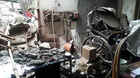 debris surrounds printing press