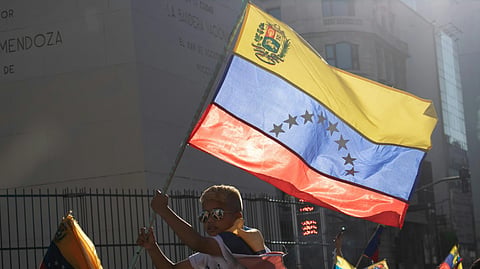 person holding the Venezuela national flag