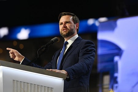 In the image JD Vance is shown addressing the people