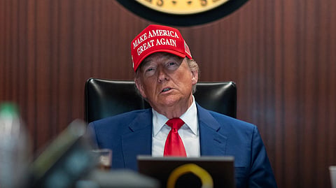 Trump wearing a MAGA cap