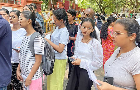 Photograph showcasing students lining up outside an examination centre