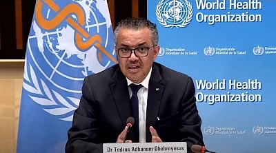 In the image WHO chief Tedros Adhanom Ghebreyesus is shown addressing a press conference