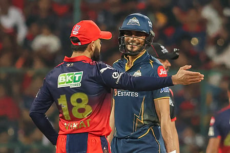 In the image Virat Kohli and Shubman Gill are shown in the cricket field 