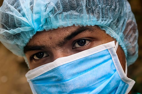In the image a doctor is shown wearing a PPE kit for treating patients with Ebola 