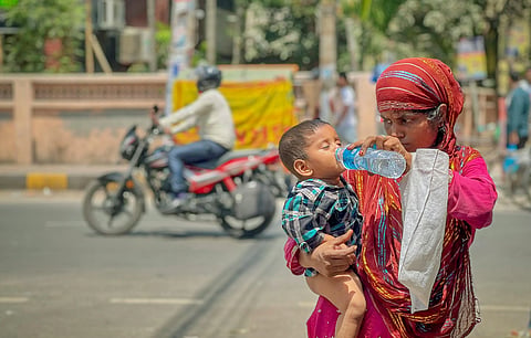 People walking through extreme heat and humidity during the ongoing South Asian heatwave in India and Pakistan