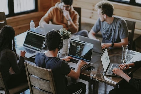 A diverse team of professionals discussing ideas and collaborating around a meeting table in an office