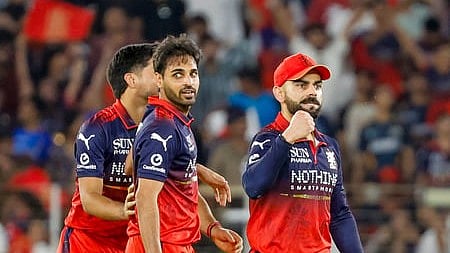 Virat Kohli with other RCB players in the cricket field