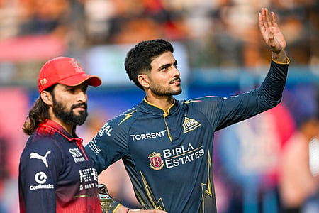 In the image two players from RCB and GT is shown in the cricket stadium ahead of IPL 2026 finals