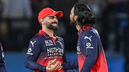 In the image RCB team is shown with Virat Kohli shaking hands with Rajat Patidar