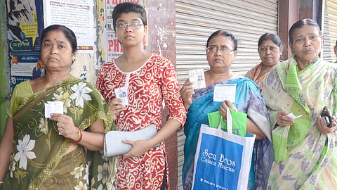 Women in West Bengal line up to vote in Kolkata, showcasing civic engagement and participation in the electoral process.