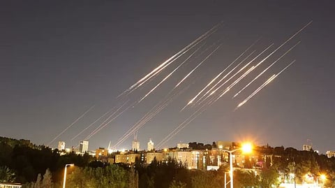 A starry night sky with several jets in flight, illustrating airstrikes taking place in Tel Aviv.