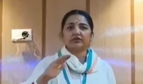 In the image TMC MP June Malia is shown speaking in a room