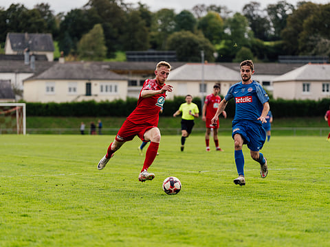 Football ground players passing ball.