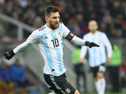 Image of Lionel Messi playing for Argentina. he is in in an Argentina jersey, number 10, kicks a ball on a grassy field. The scene is dynamic, conveying focus and intensity.
