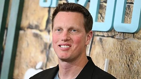 In the image the CEO of Paramount is shown smiling at the camera
