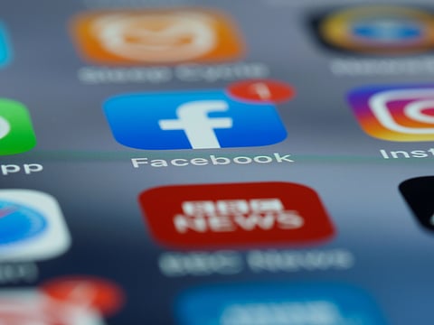 image of a social media app icon, below an icon of a news app