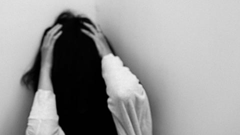 A person sitting alone in distress as a report highlights the rise in mental health-related suicides across India in 2024