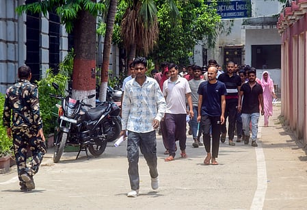 In the image many people are walking outside 