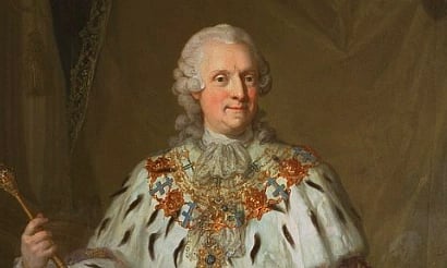 A regal portrait of a person in 18th-century attire, featuring a lavish white robe with ermine trim, gold embroidery, and a scepter, portraying a noble demeanor.