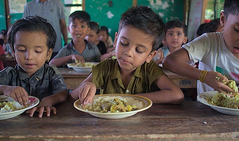 Students receiving mid-day meals in West Bengal amid controversy over egg removal and introduction of vegetarian protein options