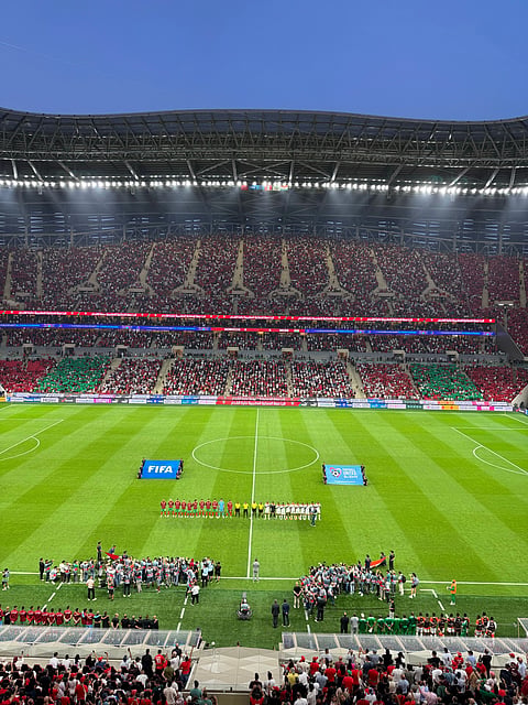 Crowed Stadium with two teams ready for football match.
