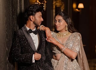 image of Ketan Agarwal and Siya Goyal. the couple are posing for a photoshoot wearing extravagant
clothes. they are looking at each other. 