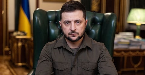 President Volodymyr Zelenskyy addresses the nation following the Bucha Massacre
In the image both his hands are placed on the table and behind him depict a formal setting.