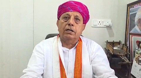 Bhagirath Choudhary, wearing pink turban and whit kurta. 