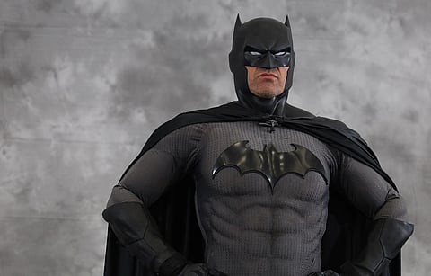 Image from San Diego Comic-Con 2024 Masquerade - Cosplay of Batman standing against a grey background
