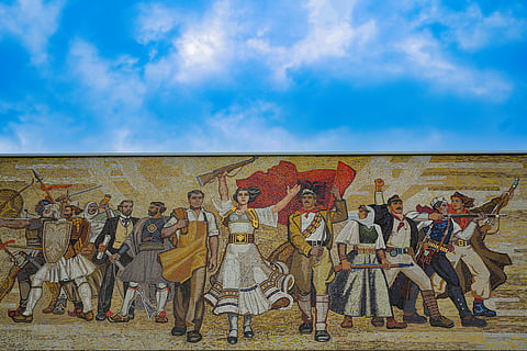 A painting where men and women are carrying weapons.