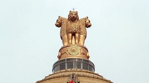 India's state emblem of Lion Capital of Ashoka mounted on top of a building.