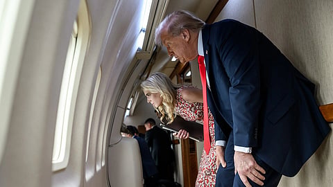 In the image President Donald Trump and Natalie Harp are shown attending the U.S. Open Men’s Championship