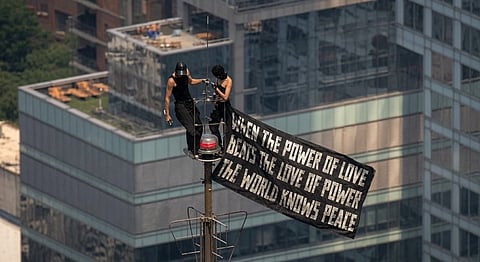 Ivan Beerkus and Angela Nikolau atop the Empire State Building after scaling the iconic skyscraper