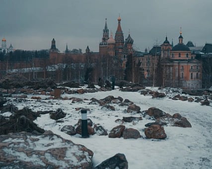 Snowy landscape with Orthodox church towers in an overcast winter setting.
