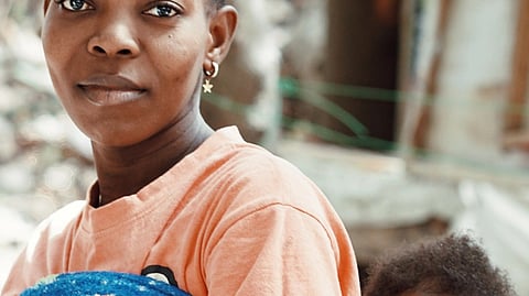 Image shows mother carrying child
