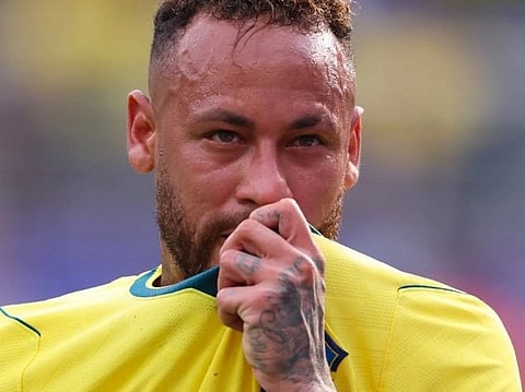 Image of Neymar crying after Brazil loosing to norway> he is holding his merch and wiping his sweat and tears with it. 