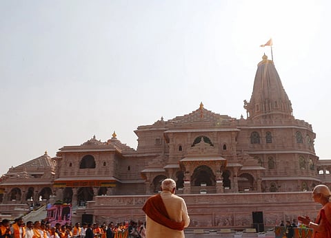 Image of PM at Shri Ram Janmbhoomi Mandir Dhwajarohan Utsav, in Ayodhya, Uttar Pradesh. In the image side of the temple is visible and PM Modi is standing at the center. 