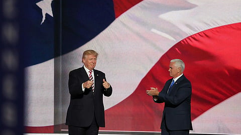 Donald Trump standing a man in black suit