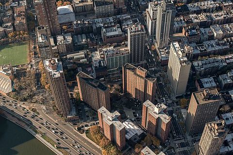Image shows a bird eye view of houses and buildings.