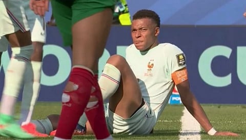 Kylian Mbappe lying on the ground