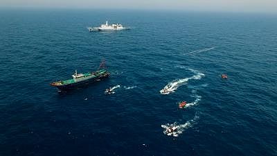 Image of ocean with several boats floating in it