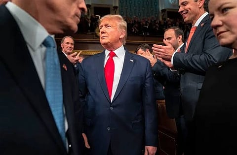 Image of US President Trump around him his officials.