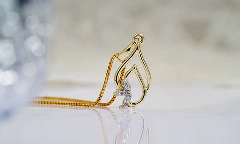 A luxurious gold and diamond pendant necklace reflecting elegance and style.

