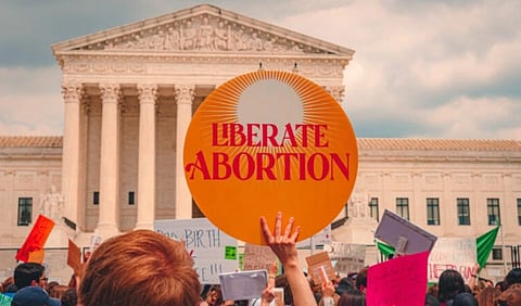 image shows a banner on which liberate abortion is written.